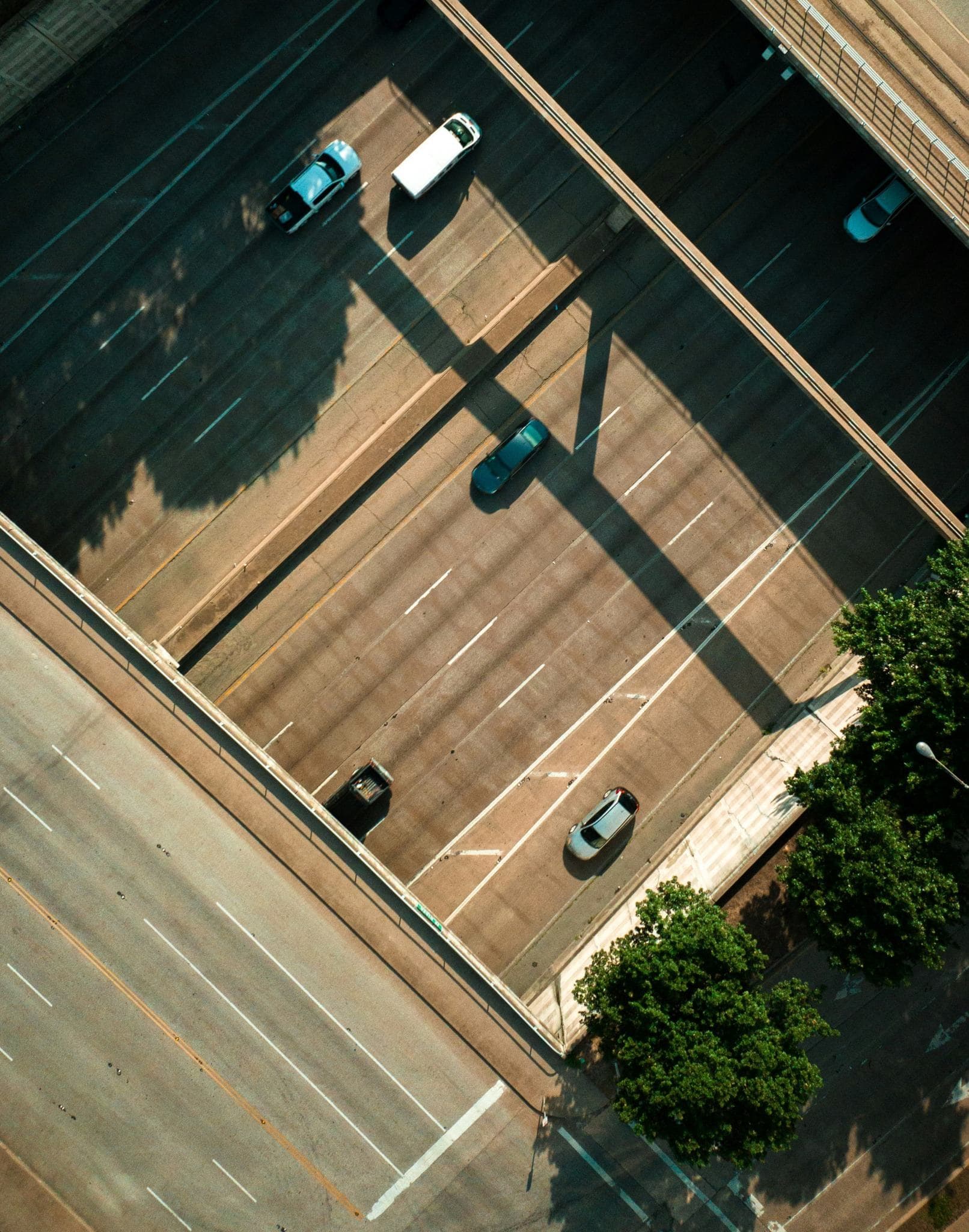 Aerial view of cars and a commercial van traveling on a multi-lane highway. Aerial view of cars and a commercial van traveling on a multi-lane highway.