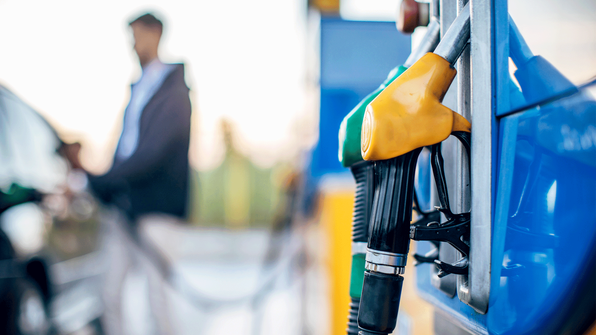 Fuel pump nozzles at a gas station with text promoting lower fuel costs and improved fleet performance. Fuel pump nozzles at a gas station with text promoting lower fuel costs and improved fleet performance.