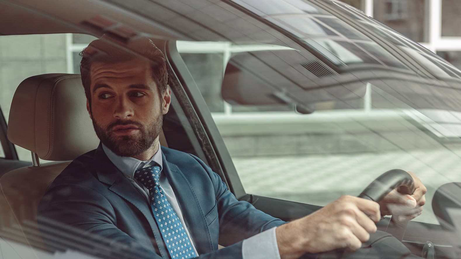 confident-businessman-driving-car confident-businessman-driving-car