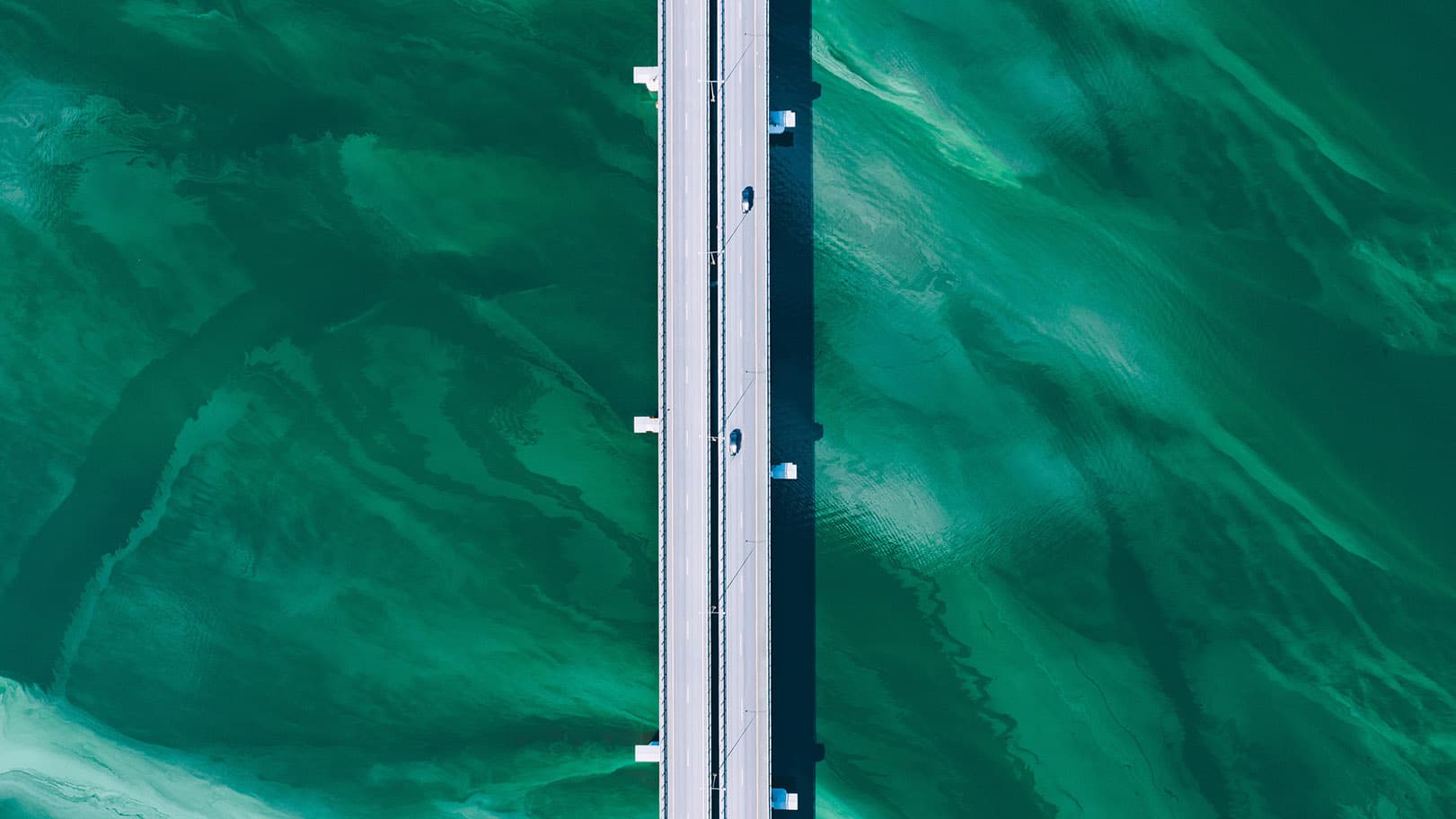 aerial-drone-view-of-asphalt-road-bridge-with-cars-2025-03-18-15-17-45-utc-16-9 aerial-drone-view-of-asphalt-road-bridge-with-cars-2025-03-18-15-17-45-utc-16-9