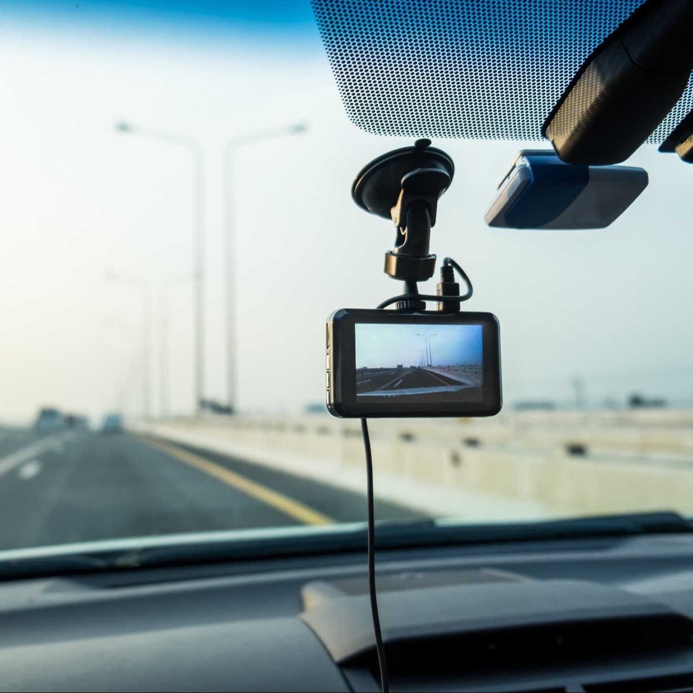 A dash cam mounted inside a vehicle records the road ahead as the vehicle travels along a multi-lane highway. A dash cam mounted inside a vehicle records the road ahead as the vehicle travels along a multi-lane highway.