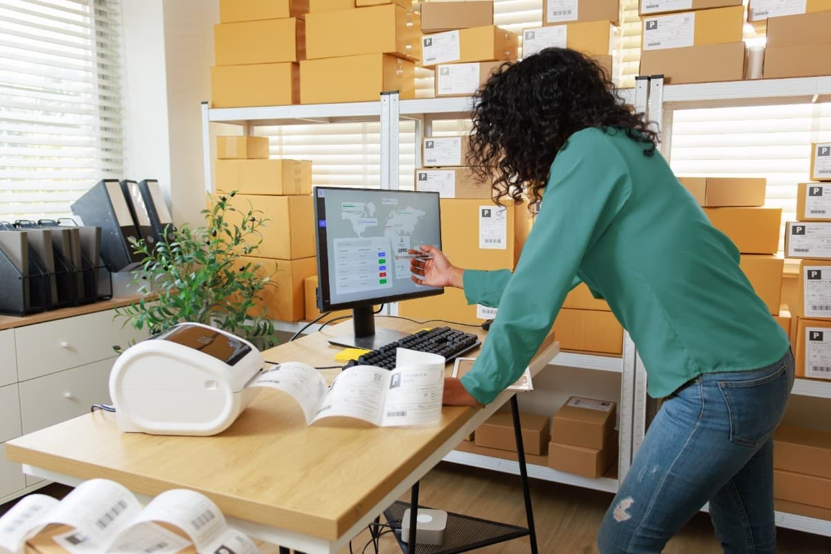 Business owner reviewing fleet operations on a computer. Business owner reviewing fleet operations on a computer.