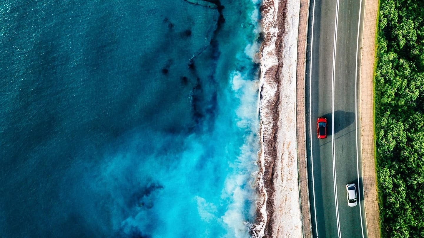 aerial-view-of-highway-road-with-cars-by-ocean-or-2025-04-08-02-35-23-utc-16-9 aerial-view-of-highway-road-with-cars-by-ocean-or-2025-04-08-02-35-23-utc-16-9